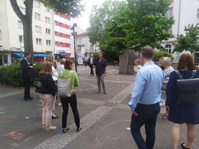 Marcus Schenk, manager of the Nordend neighbourhood office, shows the $IM group around